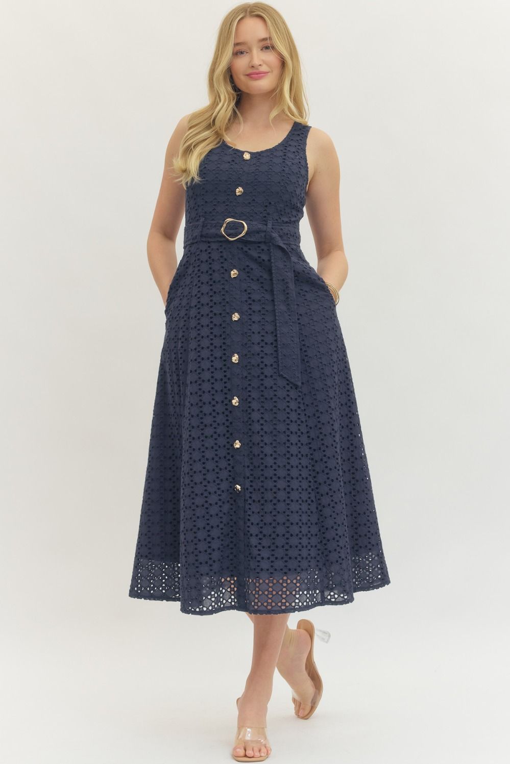 cotton eyelet midi dress with a belted waist, smocked back, and elegant, structured silhouette.