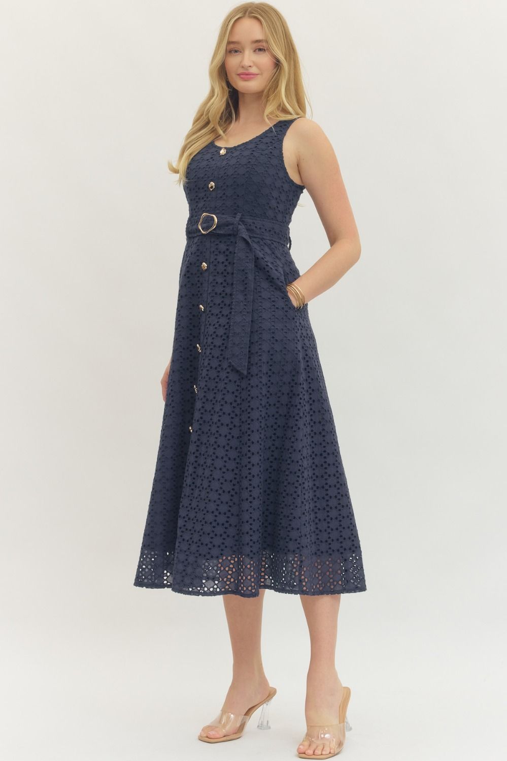 cotton eyelet midi dress with a belted waist, smocked back, and elegant, structured silhouette.
