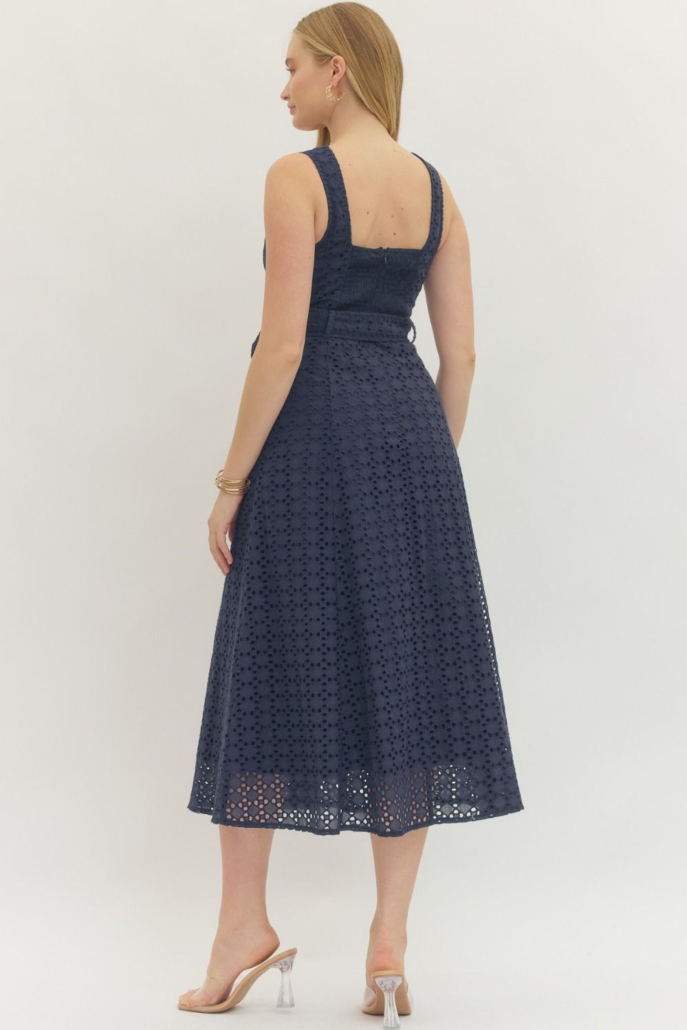 cotton eyelet midi dress with a belted waist, smocked back, and elegant, structured silhouette.