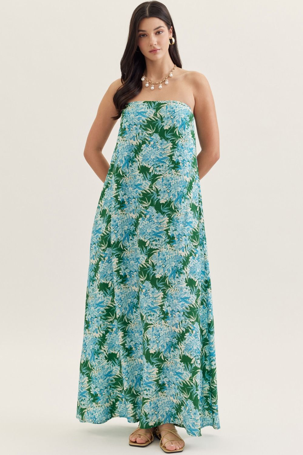 strapless maxi dress in a botanical print with a straight neckline, elastic back, and side pockets.