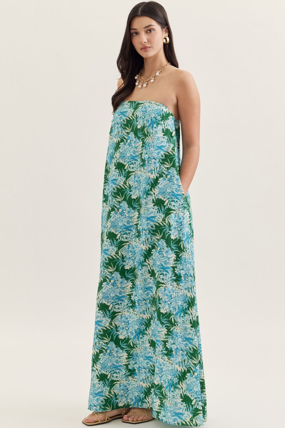 strapless maxi dress in a botanical print with a straight neckline, elastic back, and side pockets.