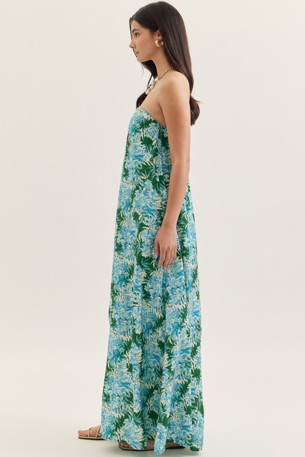 strapless maxi dress in a botanical print with a straight neckline, elastic back, and side pockets.