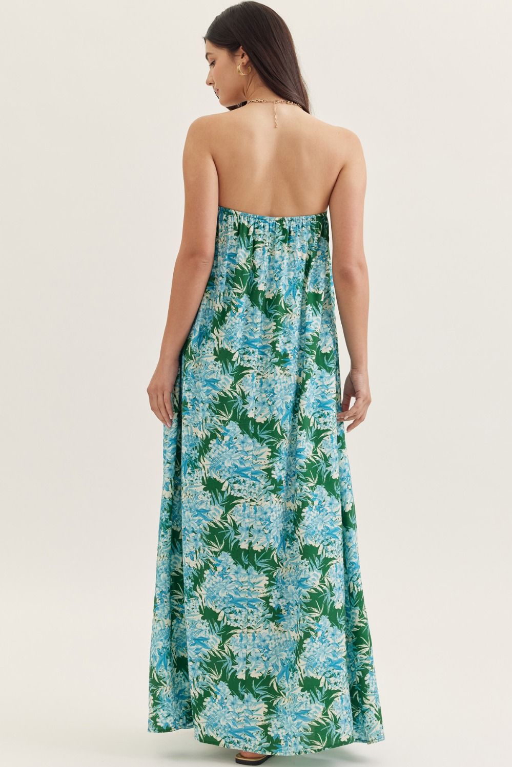 strapless maxi dress in a botanical print with a straight neckline, elastic back, and side pockets.