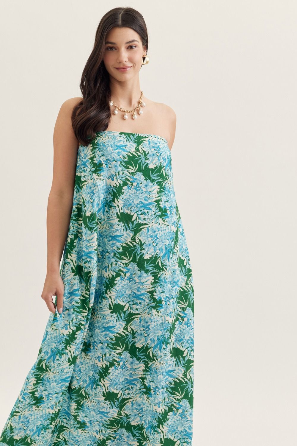 strapless maxi dress in a botanical print with a straight neckline, elastic back, and side pockets.