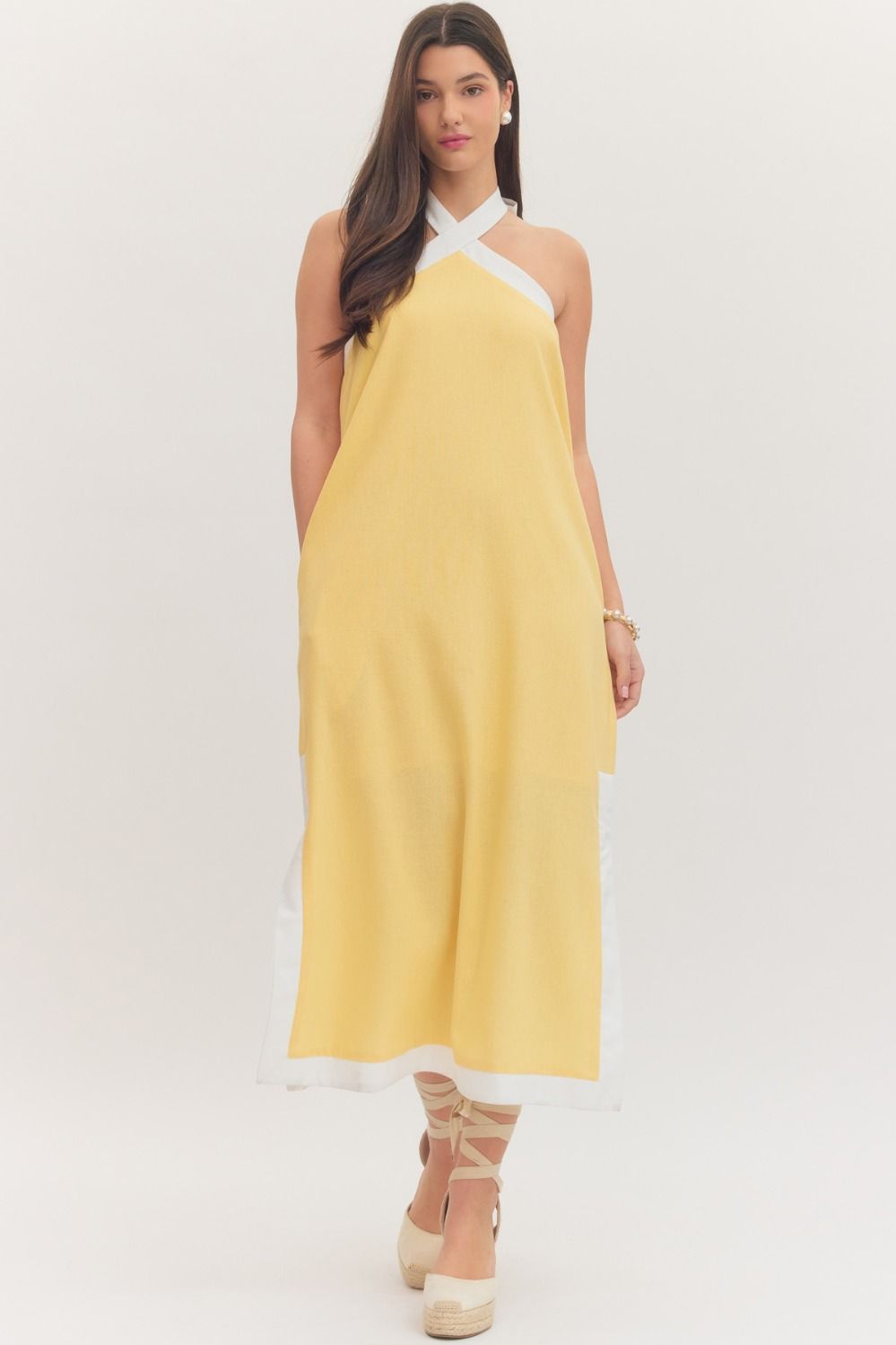 sleeveless midi dress with a cross halter neckline, self-tie back, side pockets, and side slits