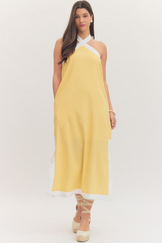 sleeveless midi dress with a cross halter neckline, self-tie back, side pockets, and side slits