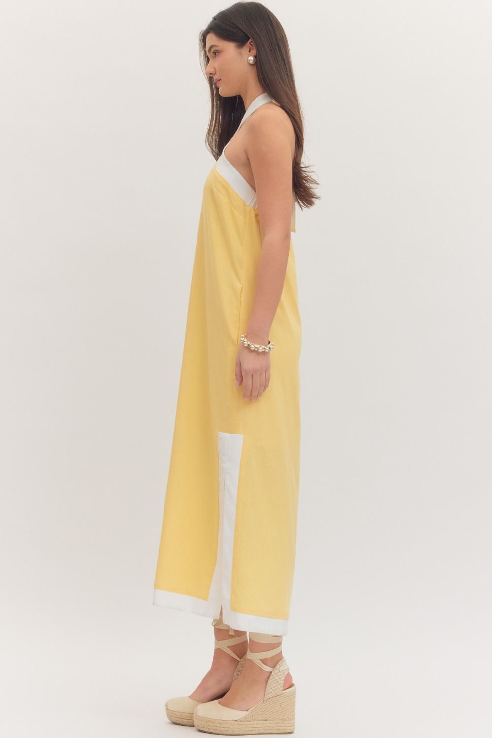 sleeveless midi dress with a cross halter neckline, self-tie back, side pockets, and side slits