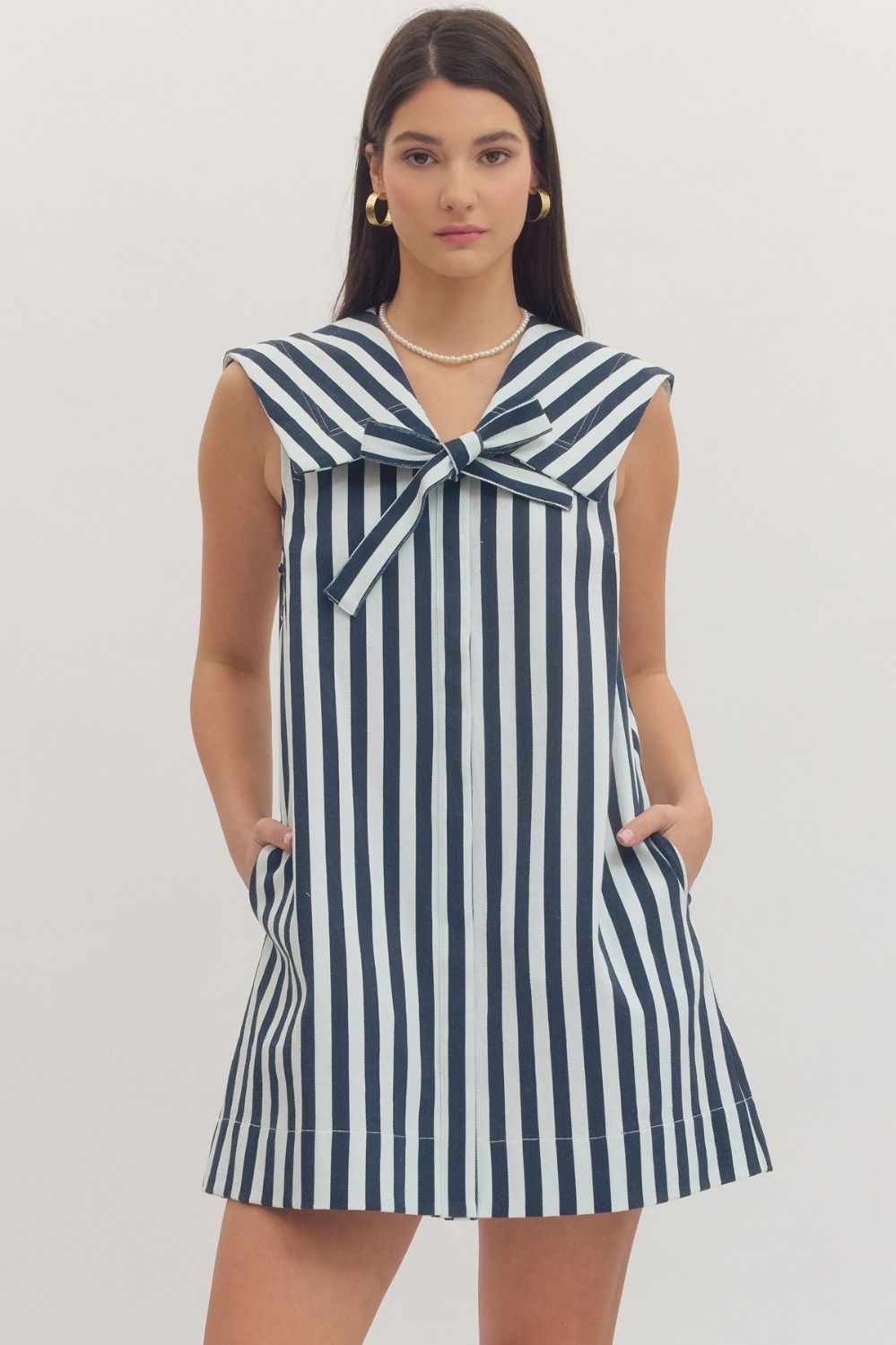 navy and white striped dress with a bow neckline 