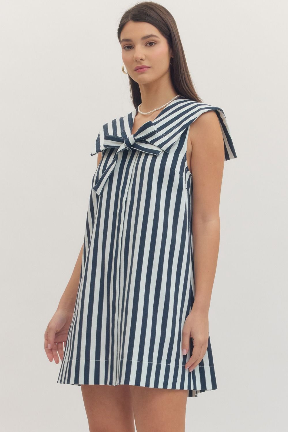 navy and white striped dress with a bow neckline 