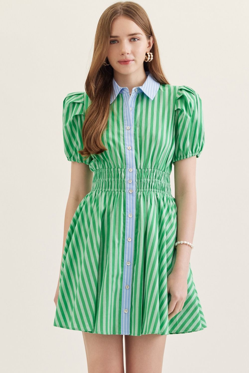  lightweight cotton mini dress with short puff sleeves, a smocked waist, and a classic stripe print