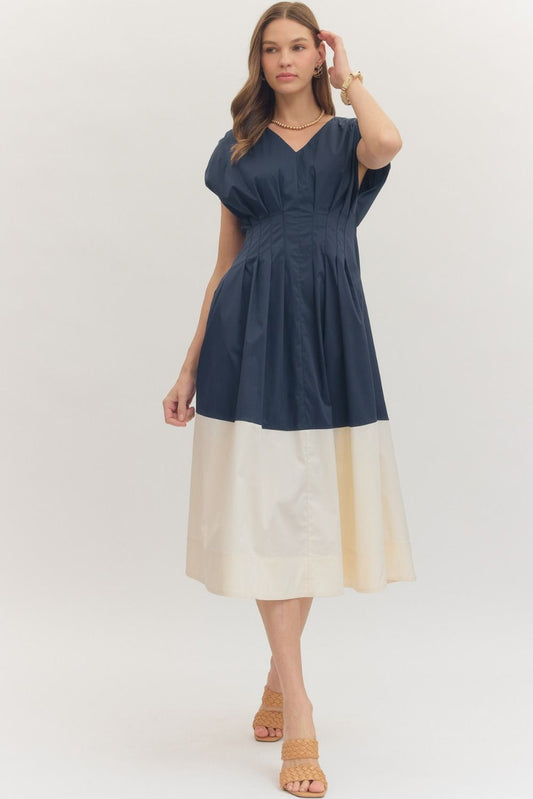  Colorblock Hem Midi Dress features a flattering pleated waist, cap sleeves, and a bold contrast hem 
