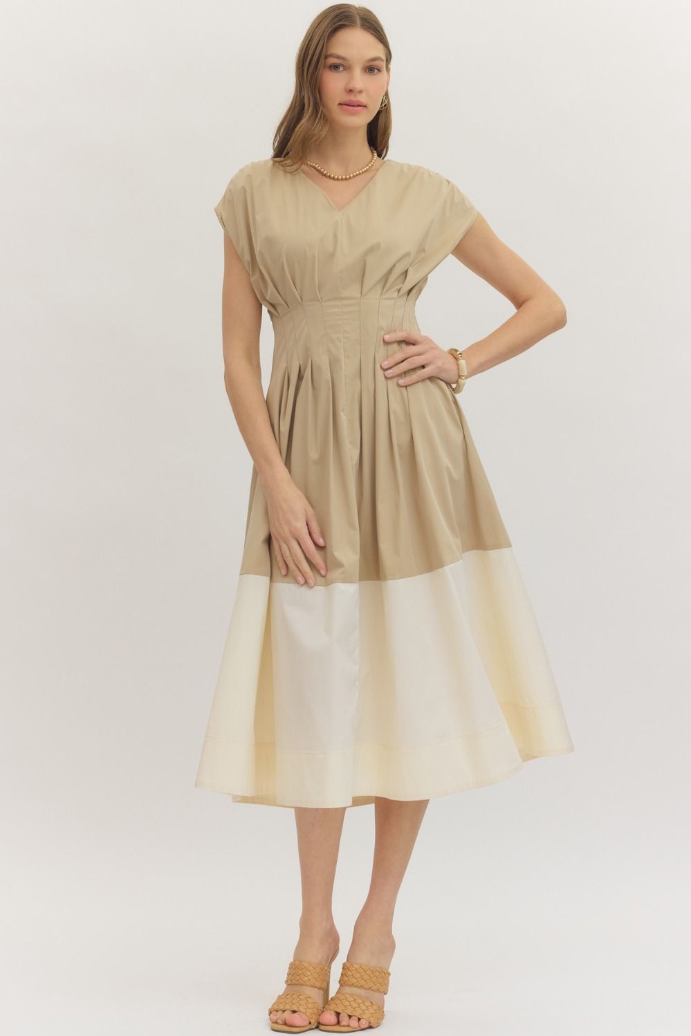  Colorblock Hem Midi Dress features a flattering pleated waist, cap sleeves, and a bold contrast hem 