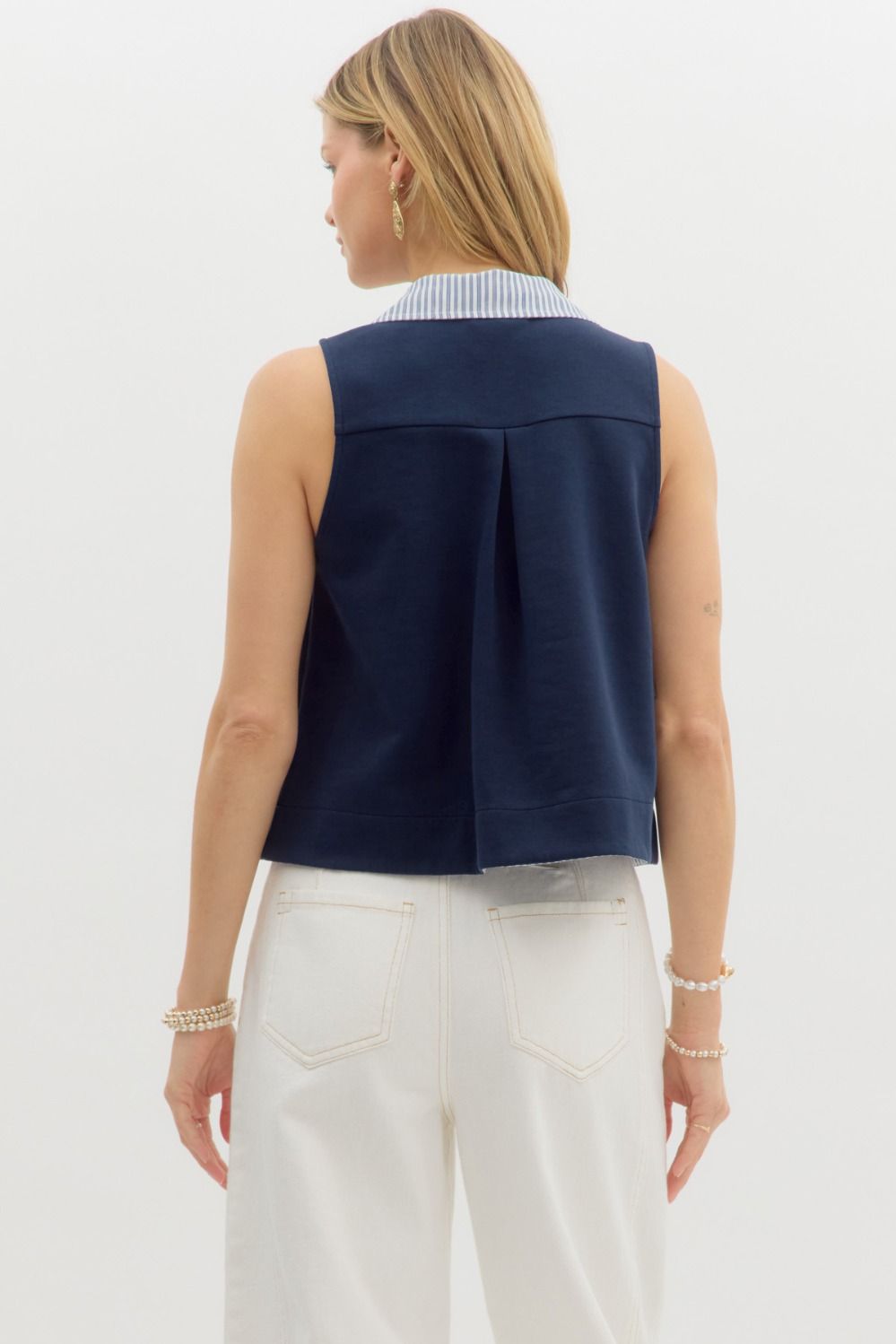  sleeveless navy top featuring a contrast striped collar and button-down placket