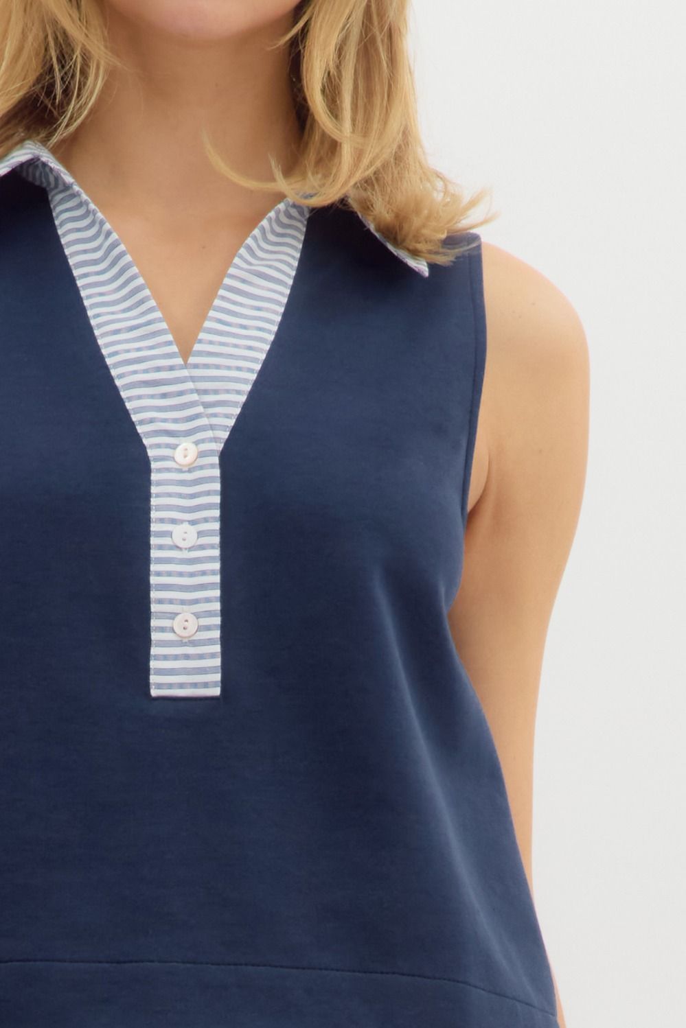  sleeveless navy top featuring a contrast striped collar and button-down placket
