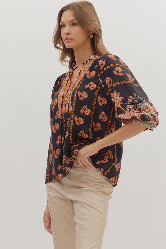 Romantic and lightweight, the Isolde top features a ruffled band collar, tassel tie neckline, and effortless drape.