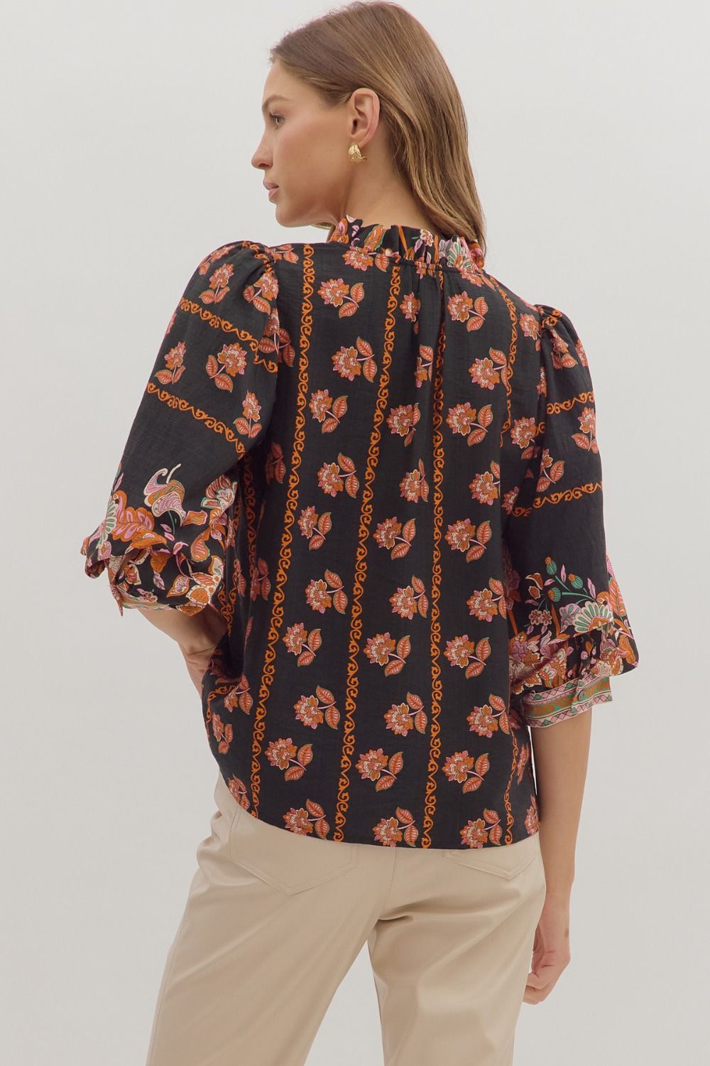 Romantic and lightweight, the Isolde top features a ruffled band collar, tassel tie neckline, and effortless drape.