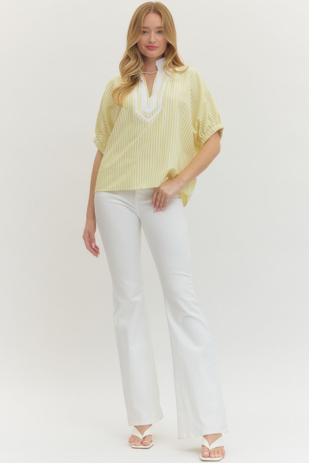 Striped woven top with short dolman sleeves, contrast V-neck panel, and relaxed fit