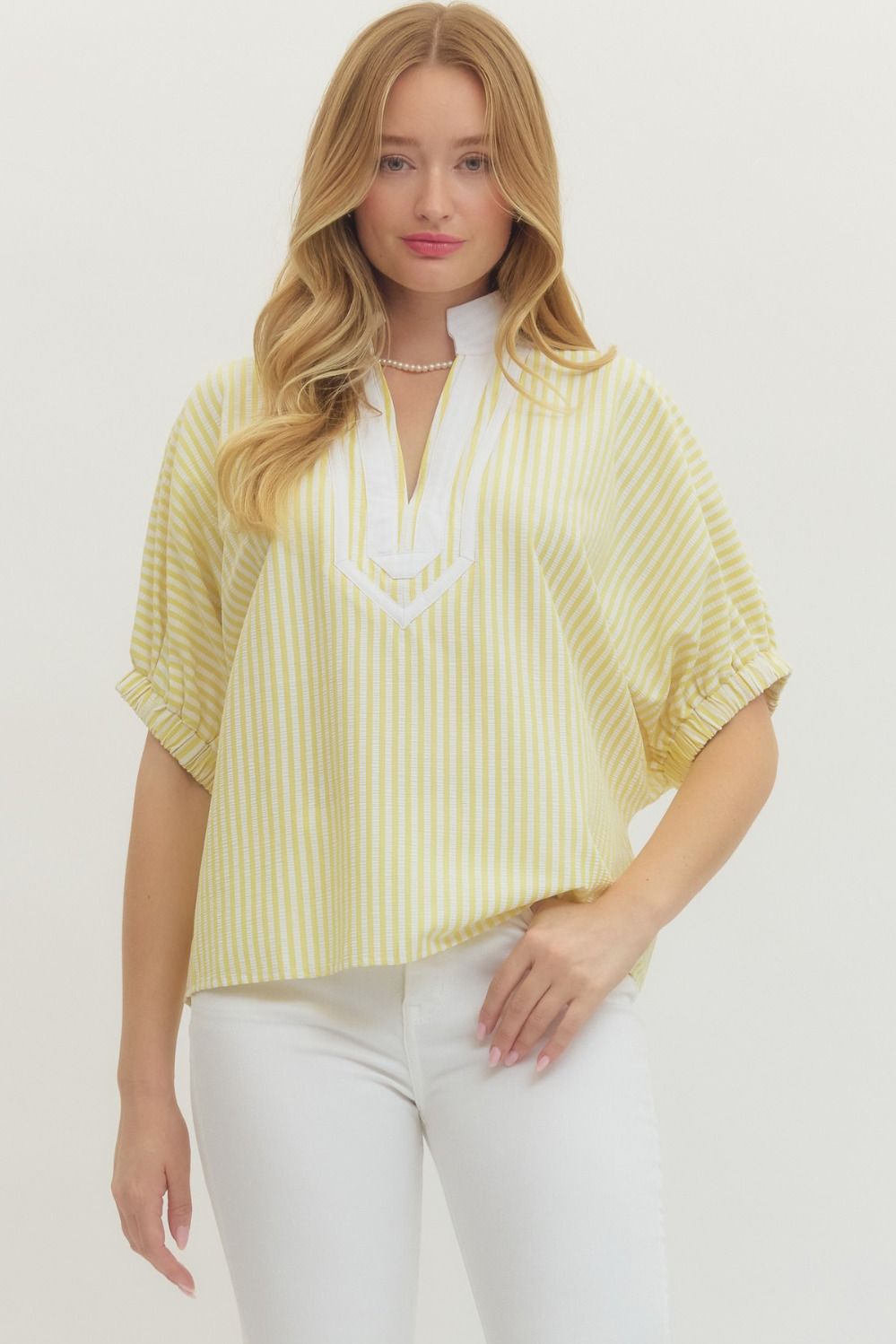 Striped woven top with short dolman sleeves, contrast V-neck panel, and relaxed fit