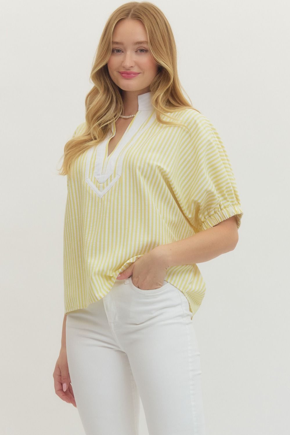 Striped woven top with short dolman sleeves, contrast V-neck panel, and relaxed fit