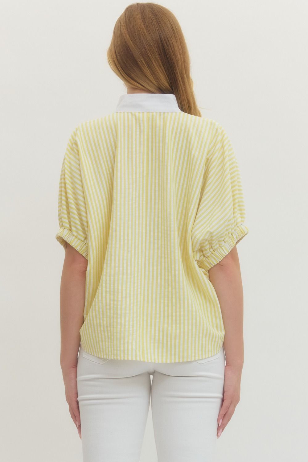 Striped woven top with short dolman sleeves, contrast V-neck panel, and relaxed fit