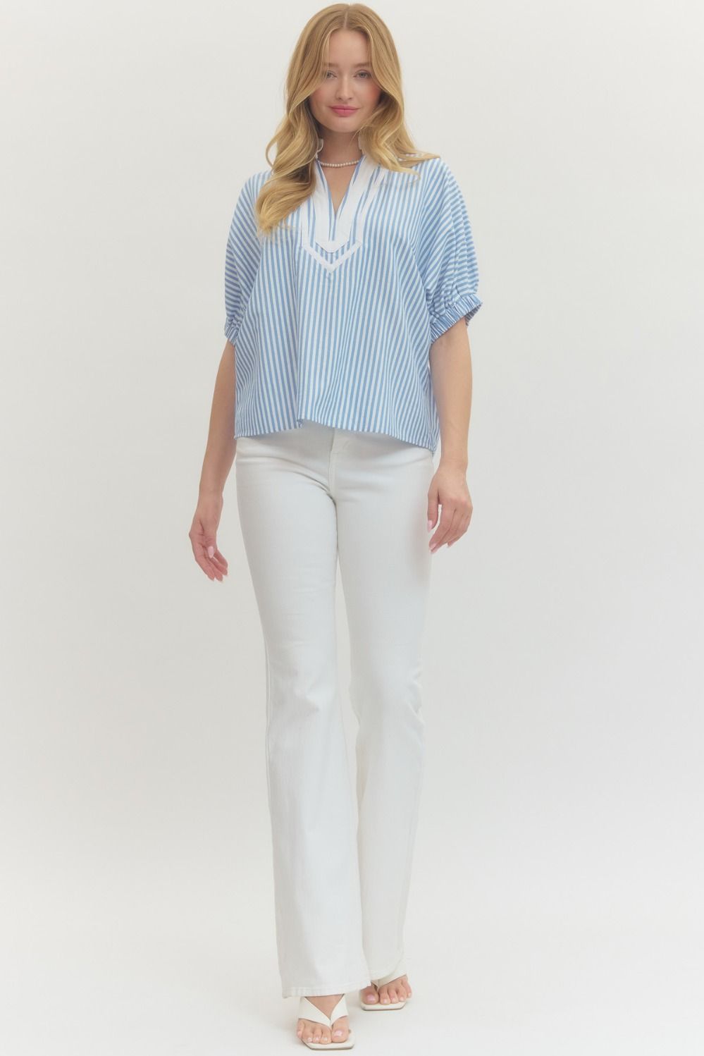 Striped woven top with short dolman sleeves, contrast V-neck panel, and relaxed fit