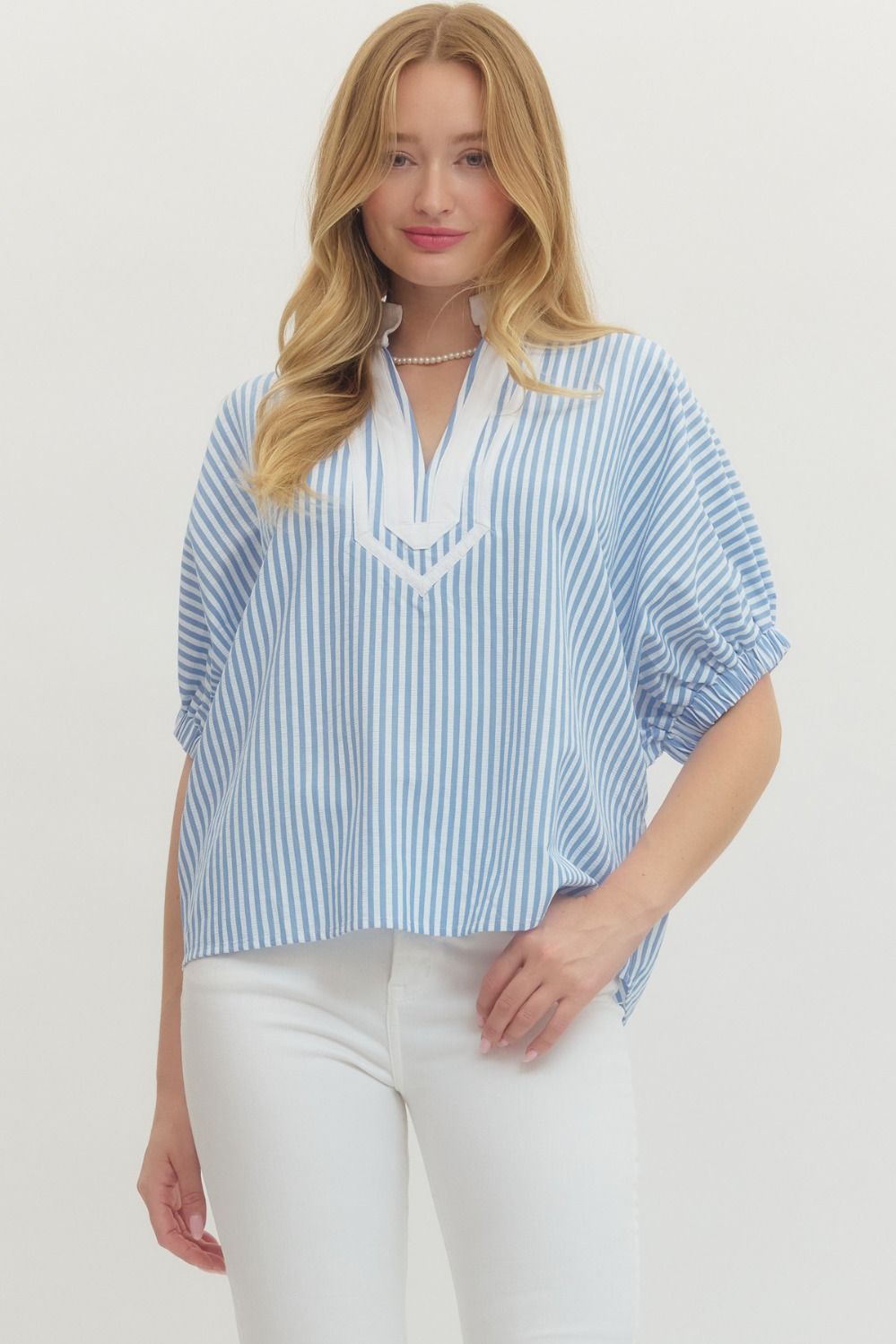 Striped woven top with short dolman sleeves, contrast V-neck panel, and relaxed fit