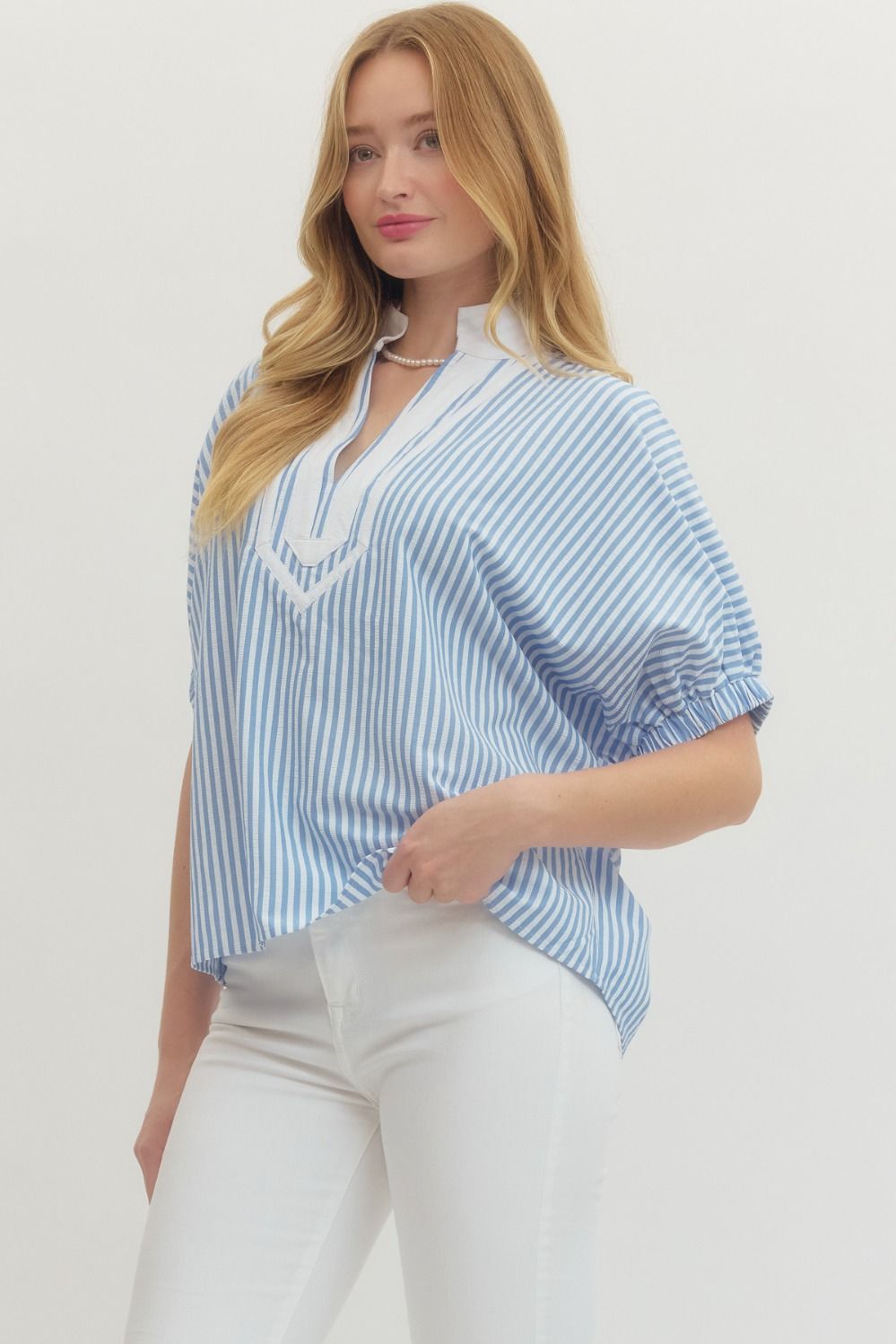 Striped woven top with short dolman sleeves, contrast V-neck panel, and relaxed fit