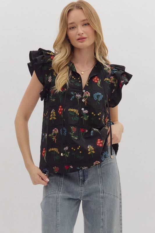 Feminine and lightweight, the Claudette top features flutter sleeves, a tiered silhouette, and a piped split neckline with button detail.