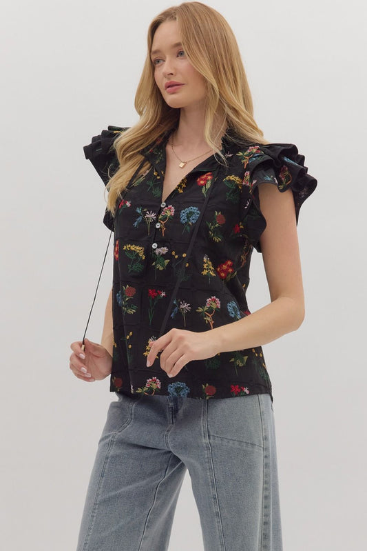 Feminine and lightweight, the Claudette top features flutter sleeves, a tiered silhouette, and a piped split neckline with button detail.