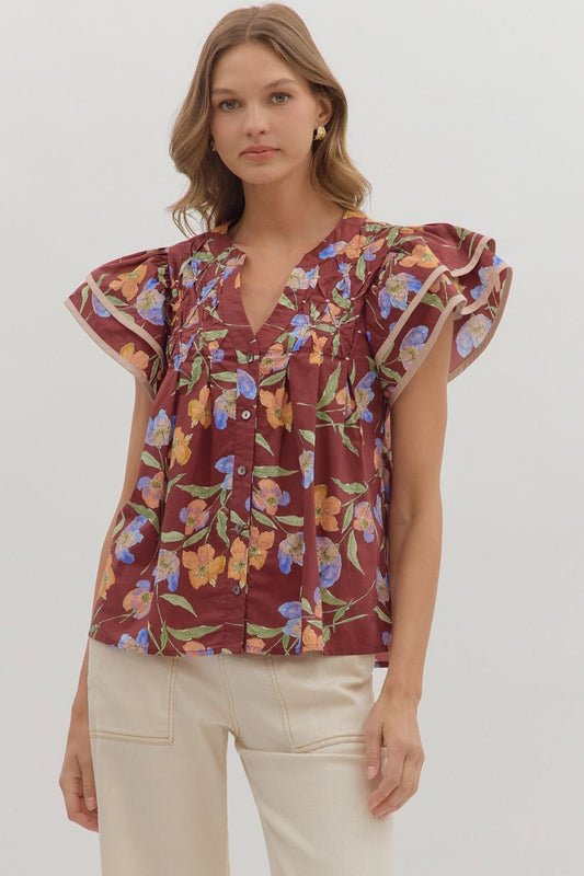 Delicate and airy, the Amelie top features flutter sleeves, pleated details, and contrast binding for feminine charm.