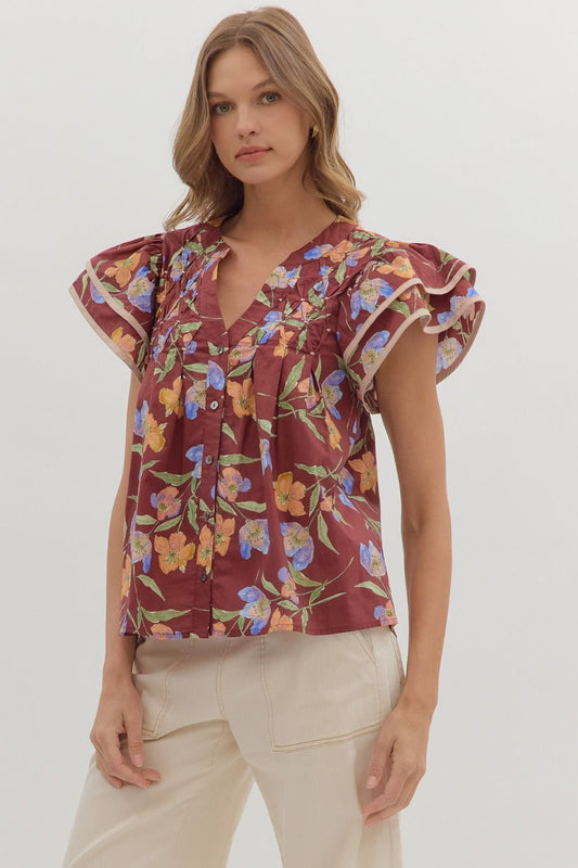 Delicate and airy, the Amelie top features flutter sleeves, pleated details, and contrast binding for feminine charm.