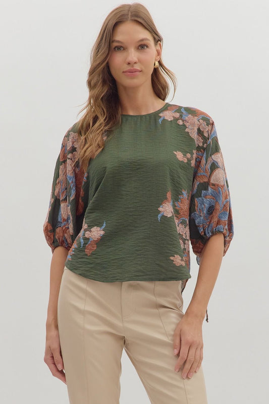 Romantic and versatile, the Dahlia top pairs a botanical print with puff sleeves and feminine tie details for effortless charm.