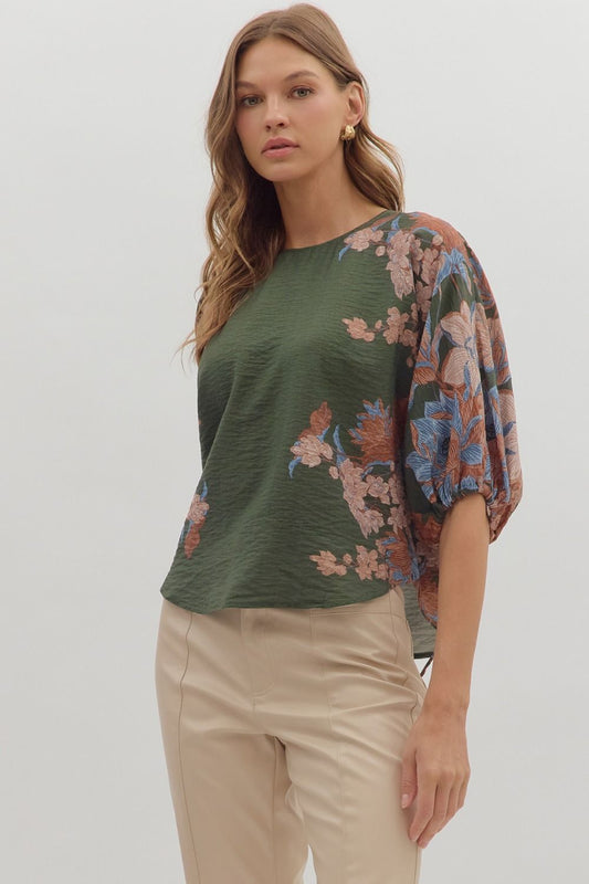 Romantic and versatile, the Dahlia top pairs a botanical print with puff sleeves and feminine tie details for effortless charm.