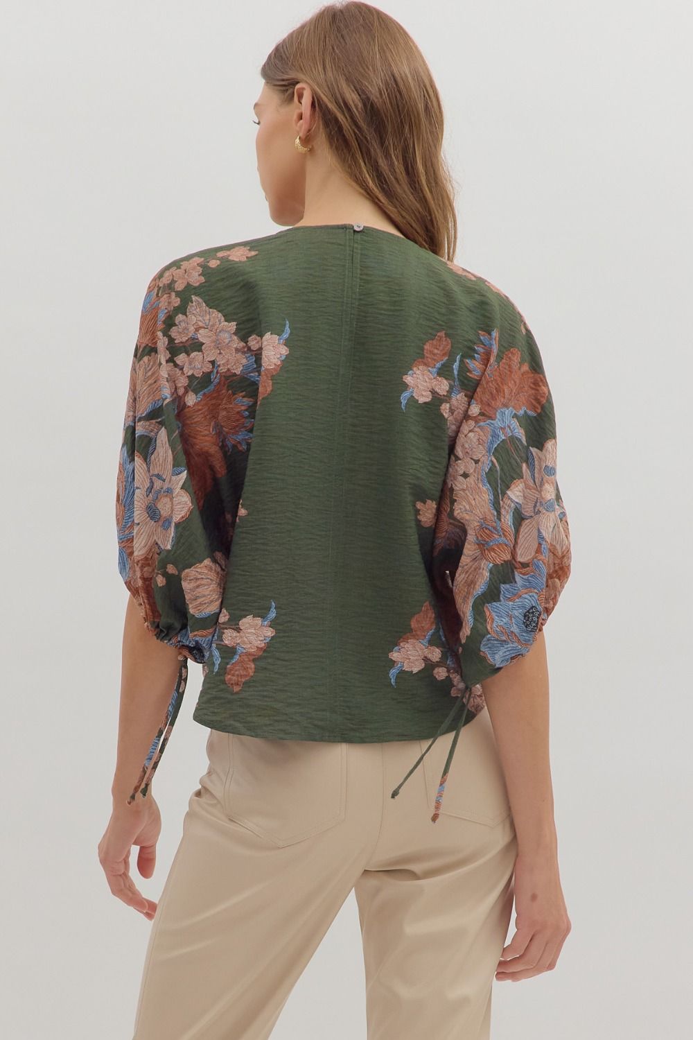Romantic and versatile, the Dahlia top pairs a botanical print with puff sleeves and feminine tie details for effortless charm.