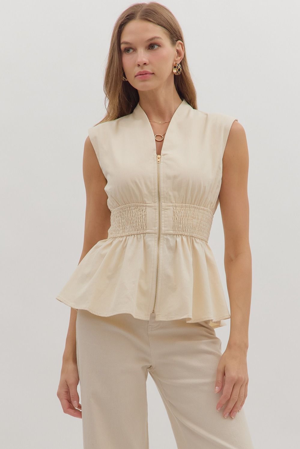 Chic and flattering, the Marceline top features a peplum silhouette with a wide smocked waist for a tailored finish.