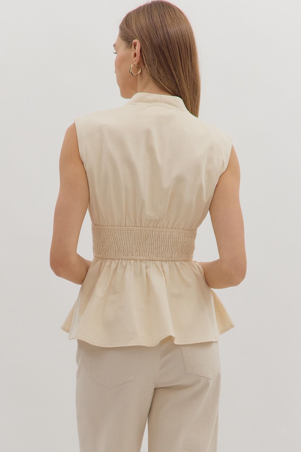 Chic and flattering, the Marceline top features a peplum silhouette with a wide smocked waist for a tailored finish.