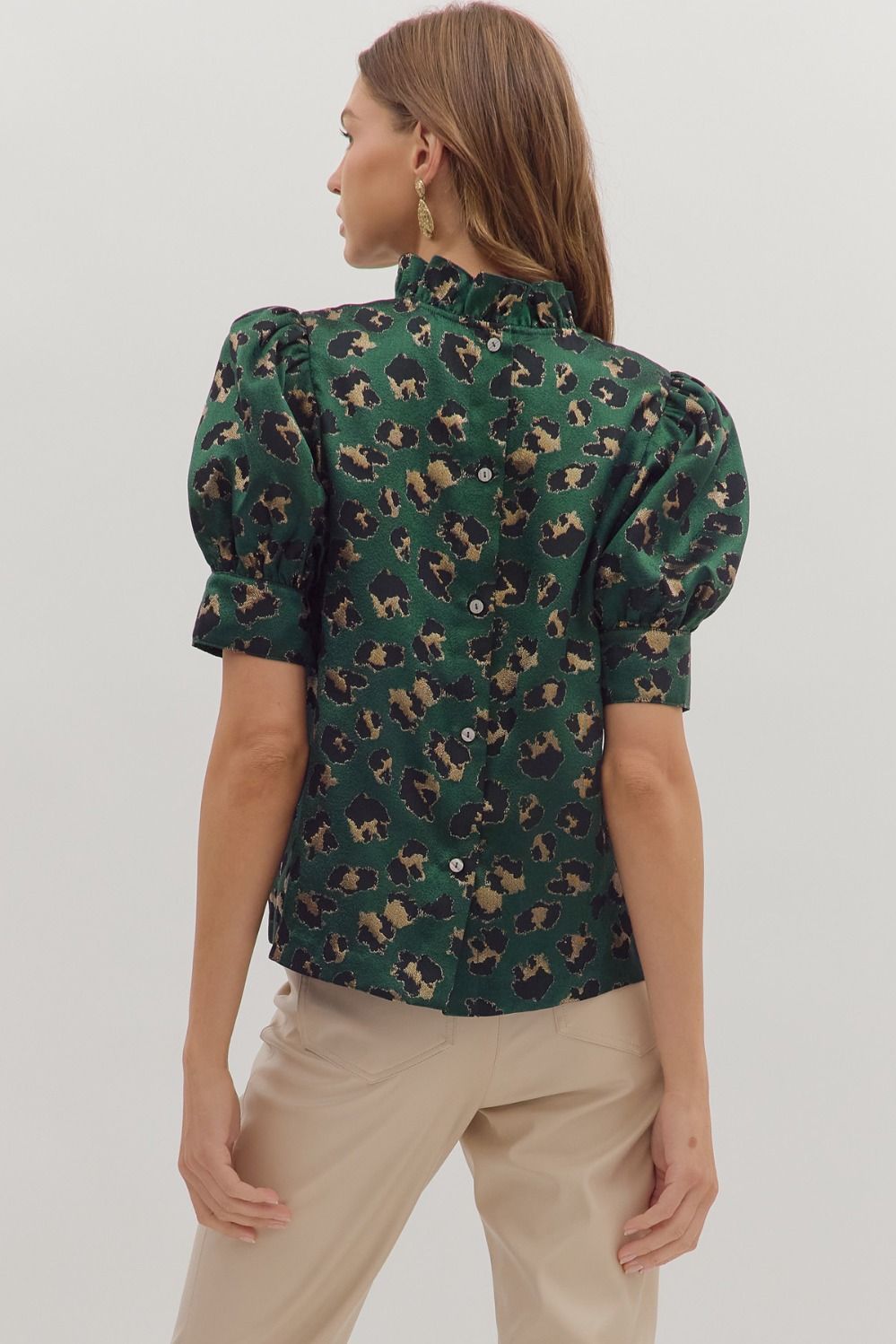 Fierce meets feminine in the Selene top, featuring a bold animal print, puff sleeves, and a ruffled mock neckline.