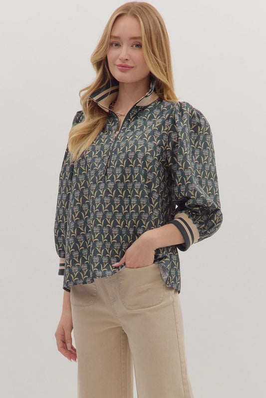 Sporty meets feminine in the Astrid top, featuring floral print puff sleeves with striped ribbed trim and a modern half-zip neckline.