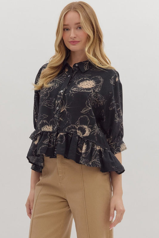 Feminine and flowy, the Colette top charms with its floral print, ruffle hem, and versatile roll-tab sleeves.
