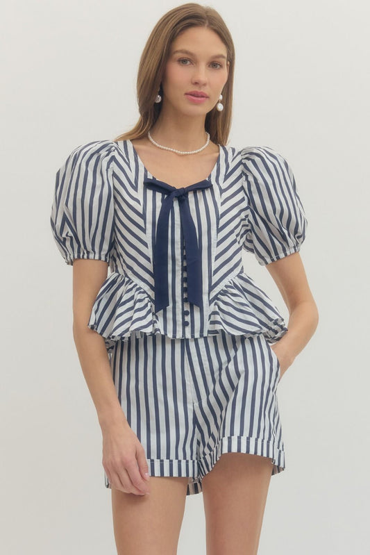 Stripe print puff sleeve peplum top with front self-tie bow detail and fabric-covered buttons.