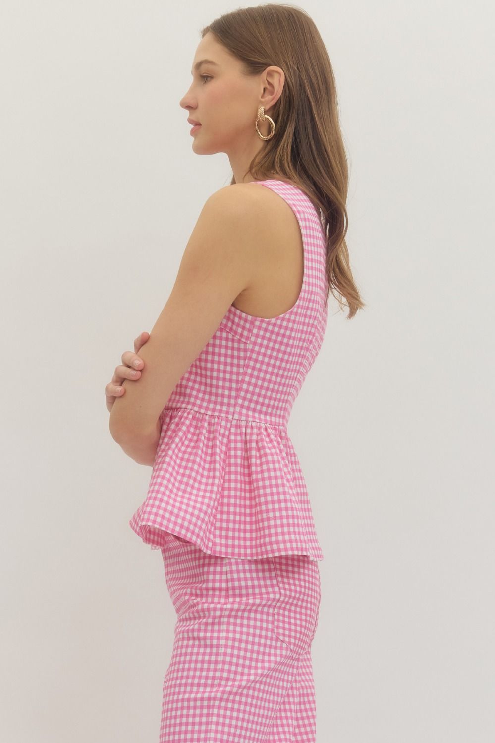 gingham sleeveless top with a structured waist seam and flattering peplum silhouette