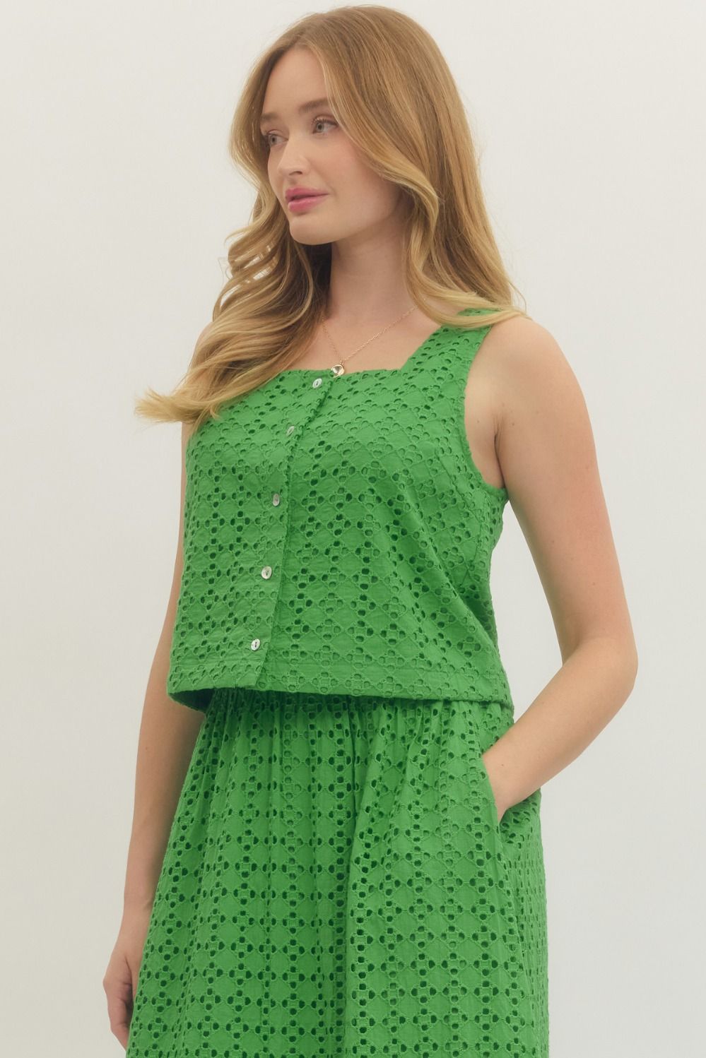 cotton eyelet sleeveless top with button-front closure and a clean, feminine finish