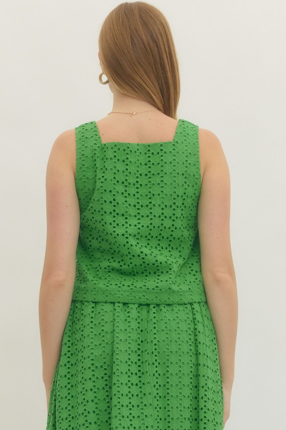 cotton eyelet sleeveless top with button-front closure and a clean, feminine finish