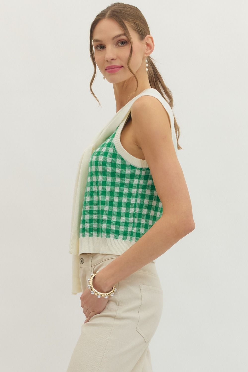 lightweight sleeveless gingham knit top with a draped sweater detail tied at the front.
