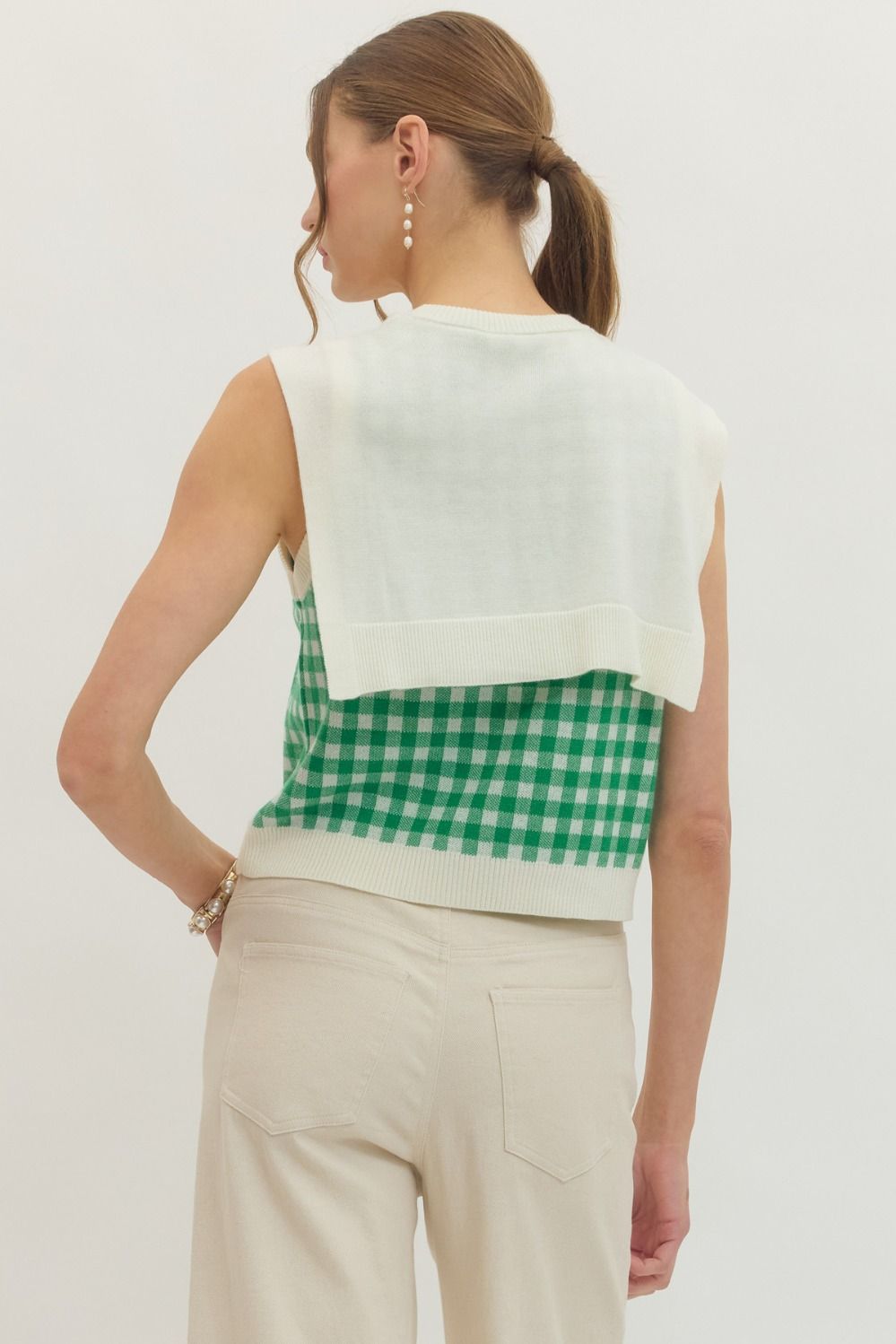 lightweight sleeveless gingham knit top with a draped sweater detail tied at the front.