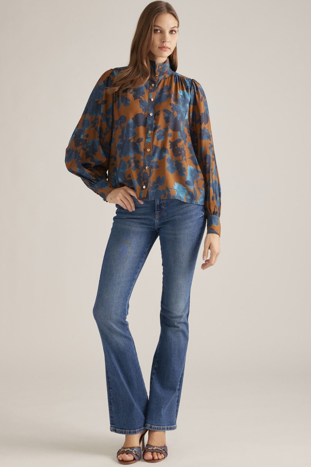 Women's floral woven blouse with stand collar, long puff sleeves, button-front closure, and gathered back yoke