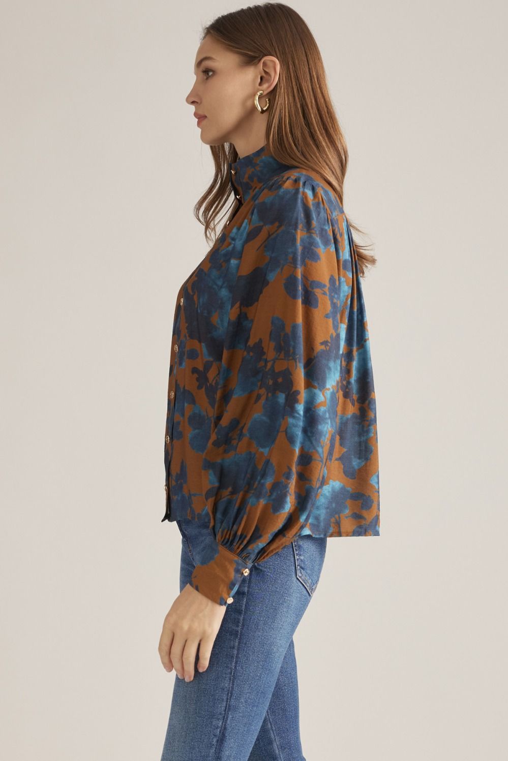 Women's floral woven blouse with stand collar, long puff sleeves, button-front closure, and gathered back yoke