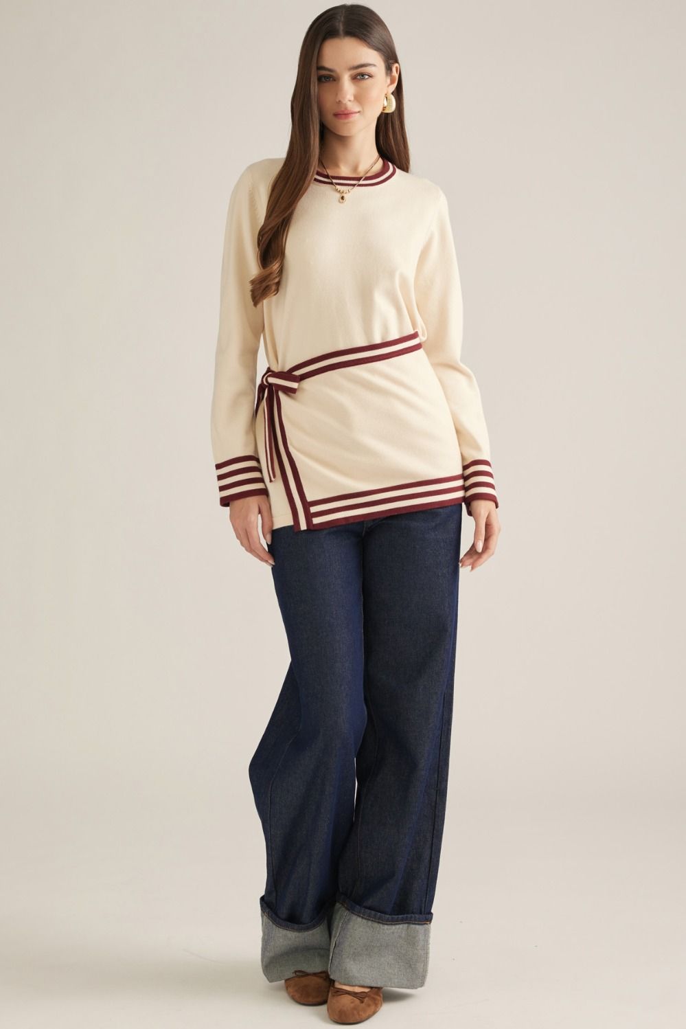 Solid long sleeve knit sweater top with contrast stripe trim and detachable wrap-style waist panel with self-tie detail