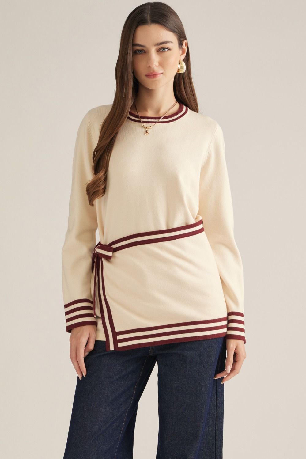 Solid long sleeve knit sweater top with contrast stripe trim and detachable wrap-style waist panel with self-tie detail