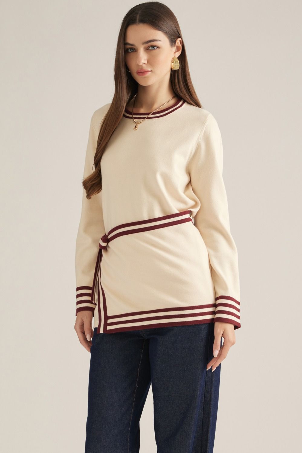 Solid long sleeve knit sweater top with contrast stripe trim and detachable wrap-style waist panel with self-tie detail